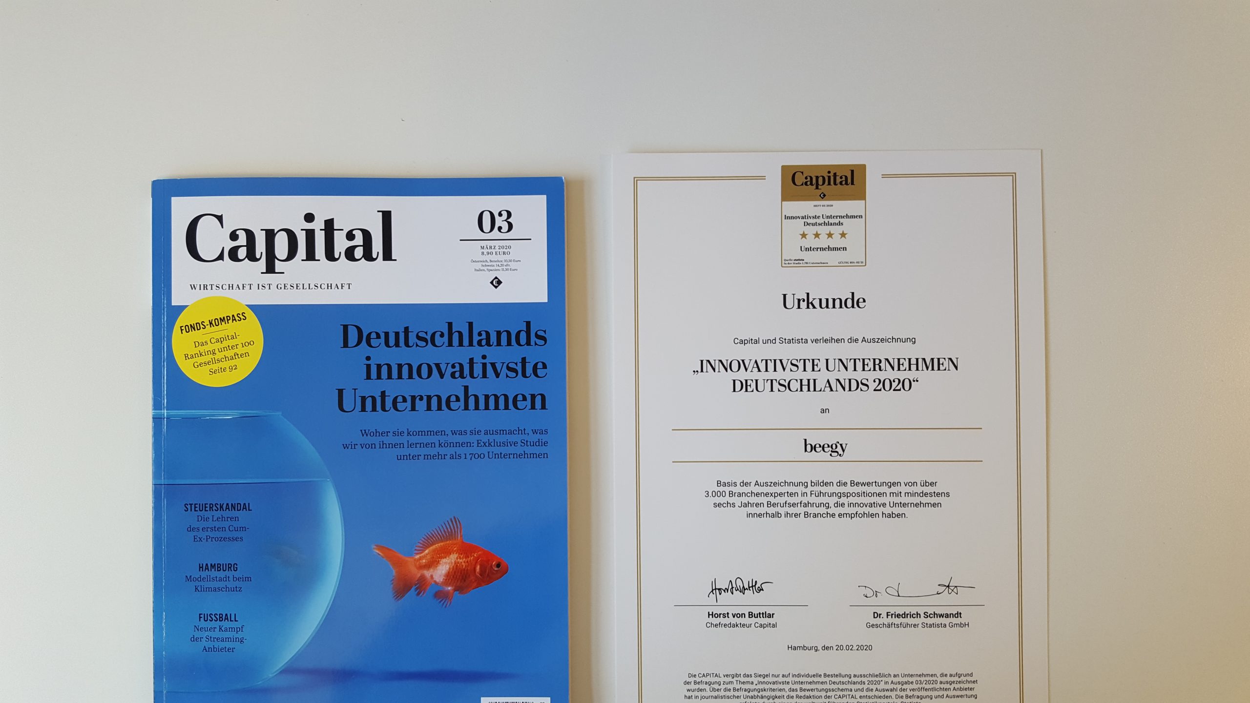 A Capital magazine issue and a certificate titled Most Innovative Companies in Germany 2020 from Capital and Statista are displayed side by side on a white surface.